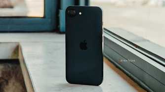 iPhone 16e back (angled) in front of window.