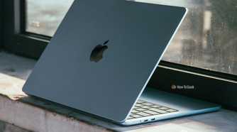 M4 MacBook Air in Sky Blue in darker scene on ledge.
