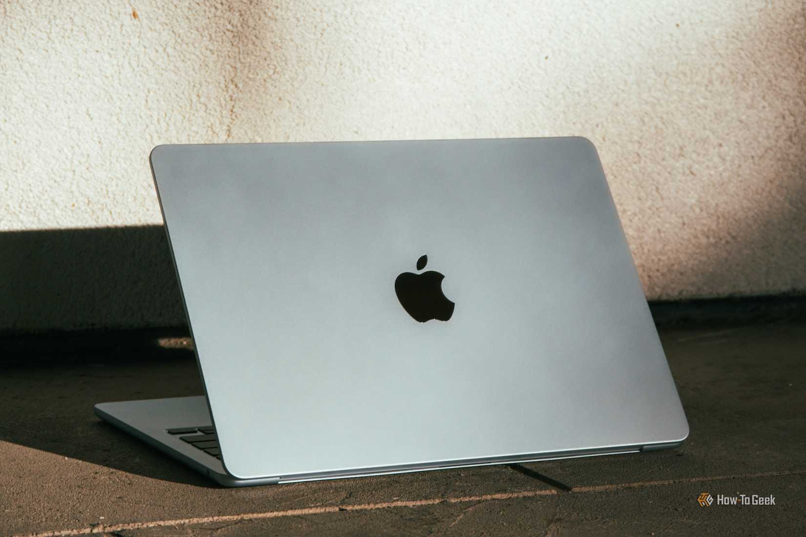 M4 MacBook Air in Sky Blue on the floor against white background.