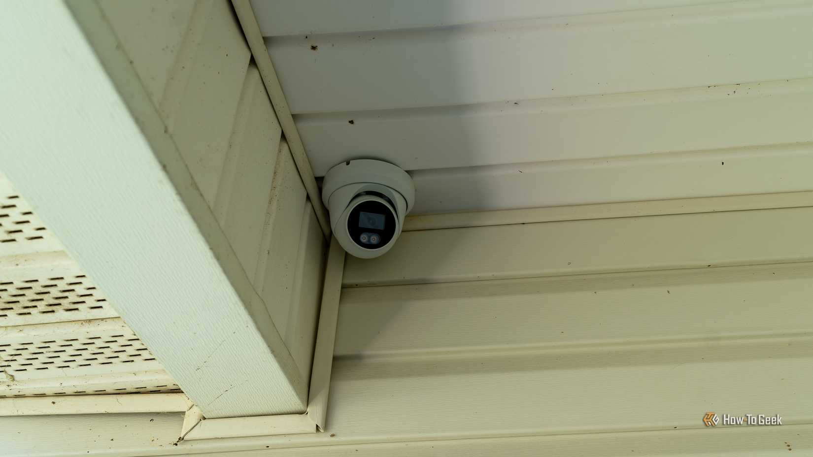 A PoE security camera mounted in the corner of a porch.