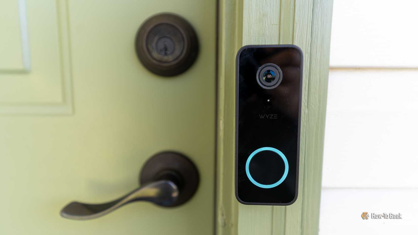 The Wyze Video Doorbell V2 mounted to a green front door.