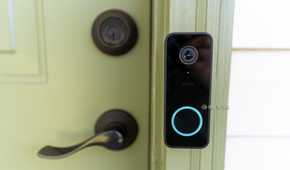 The Wyze Video Doorbell V2 mounted to a green front door.