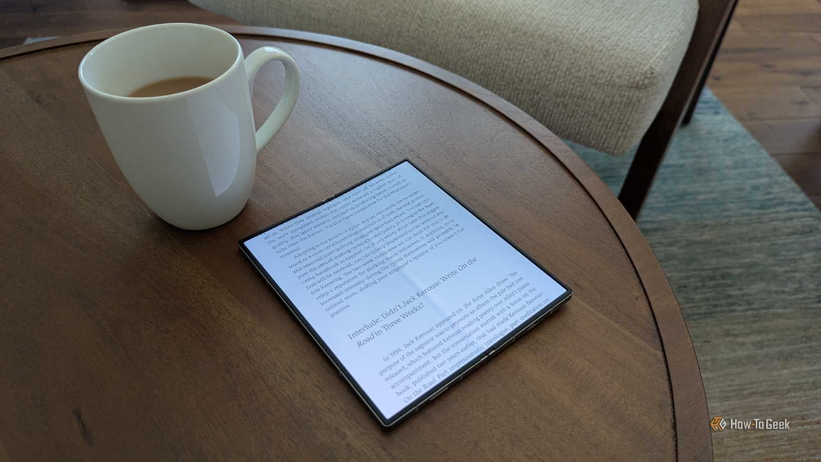 An eBook on a Galaxy Z Fold 6 next to a mug of tea.