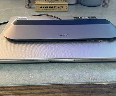 The Belkin Connect 11-in-1 USB-C Pro Dock sitting on top of a laptop.