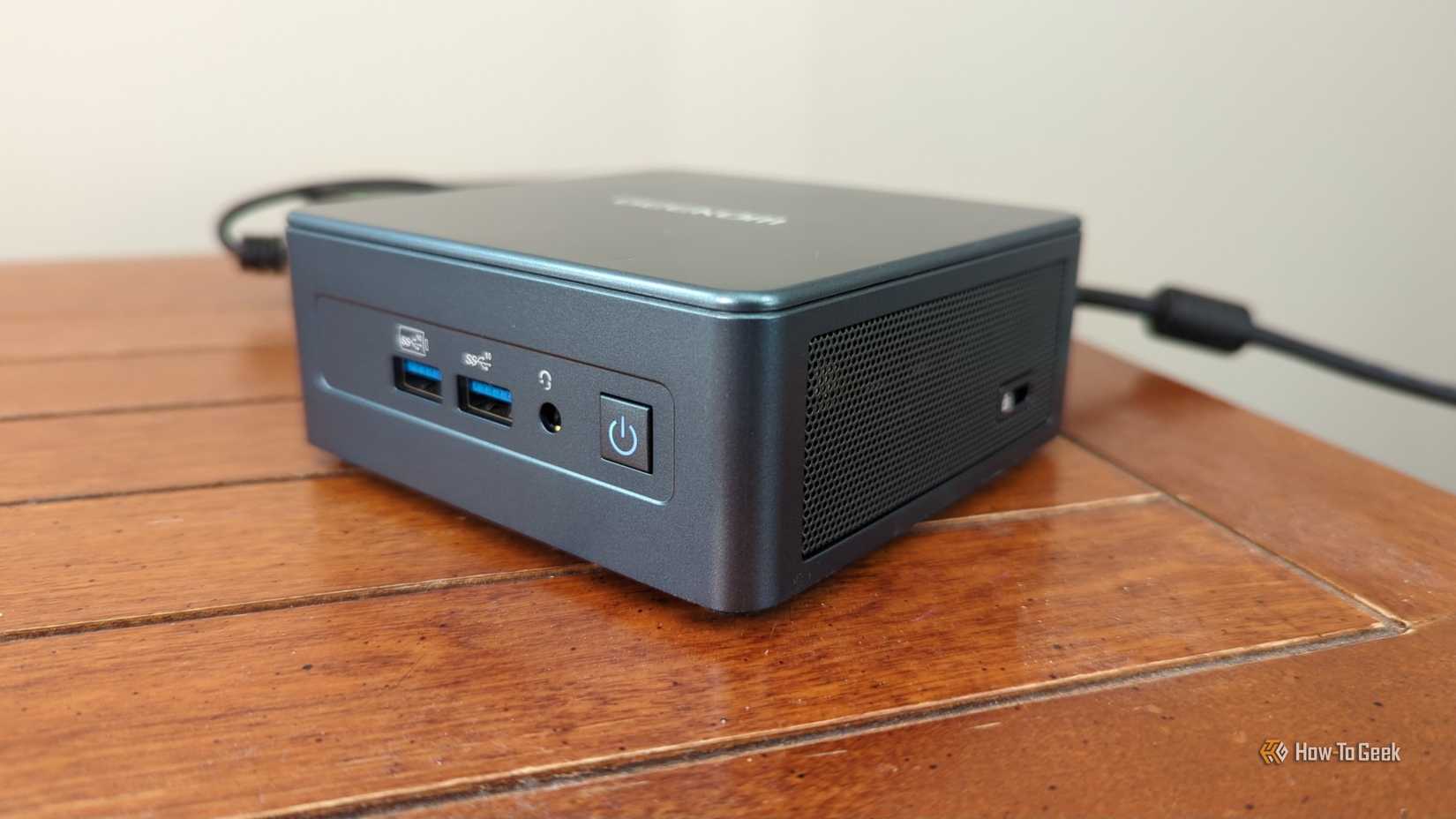 A Geekom mini PC plugged in and powered on.-1
