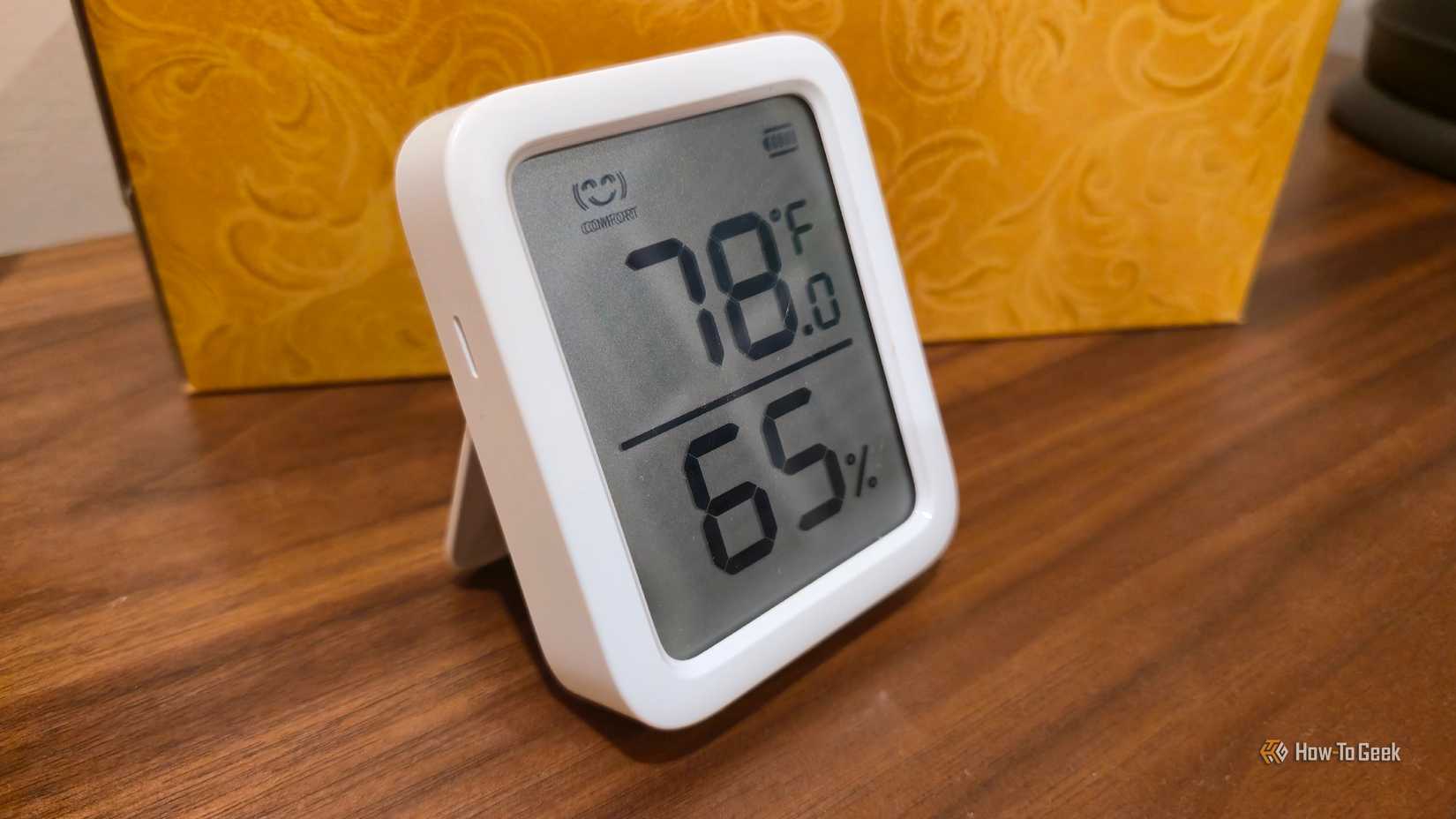 A SwitchBot Meter Plus on a table.