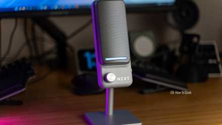 The NZXT Capsule Elite USB microphone sitting on a desk.