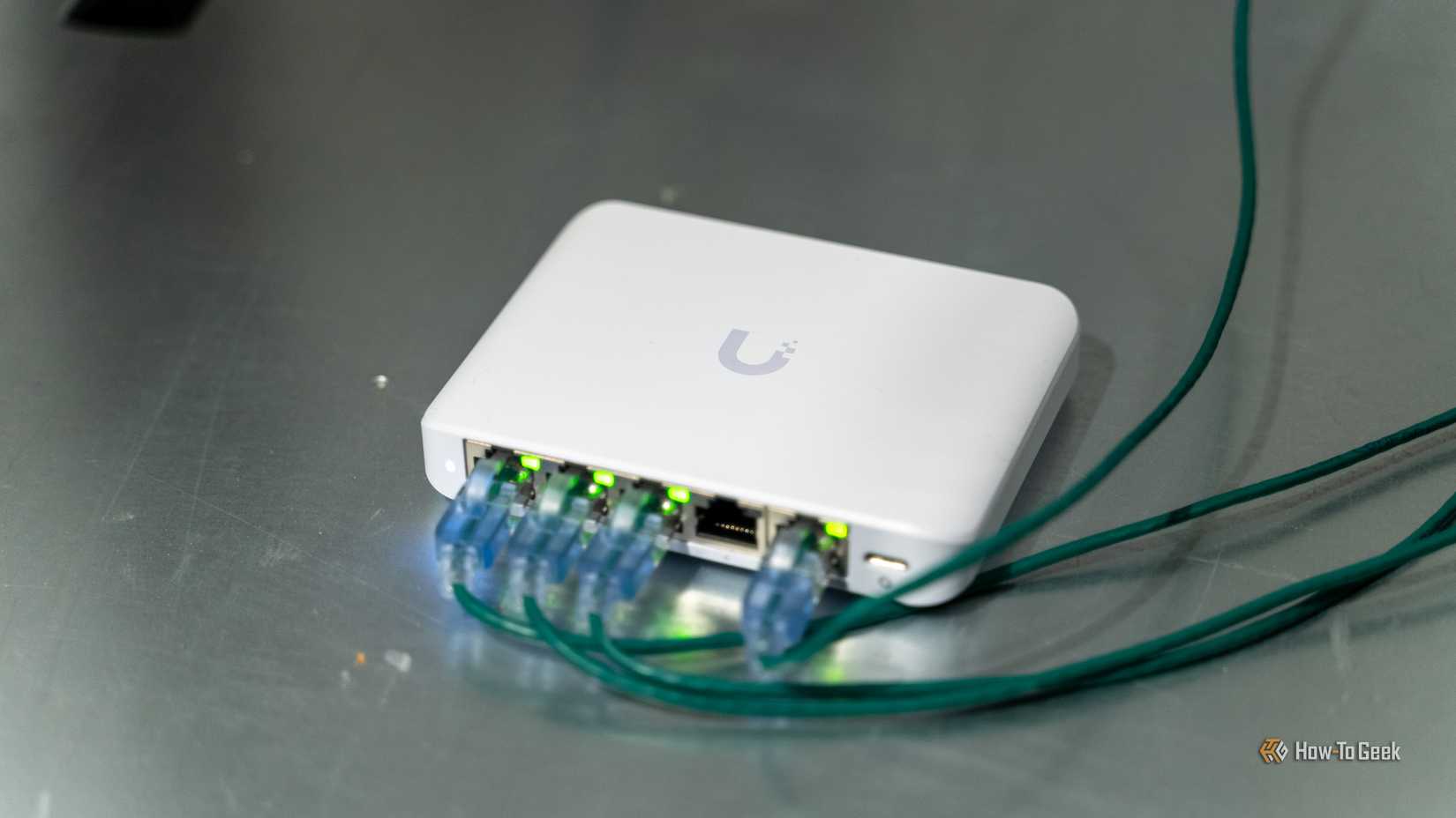 O switch Ethernet Unifi Flex Mini 2.5G com cabos conectados em um servidor.