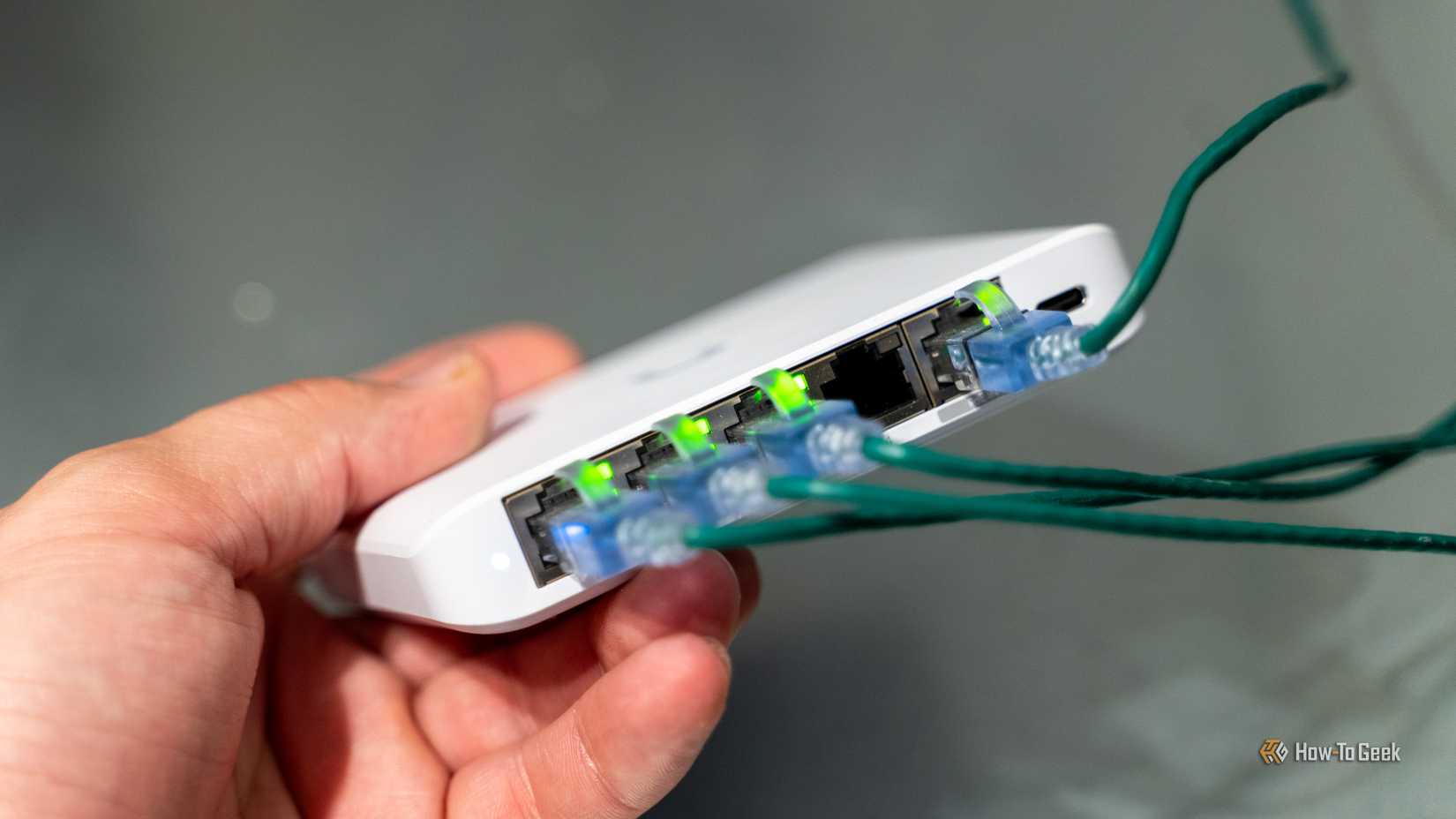 The ports on the Unifi Flex Mini 2.5G Ethernet switch with the link lights illuminated.