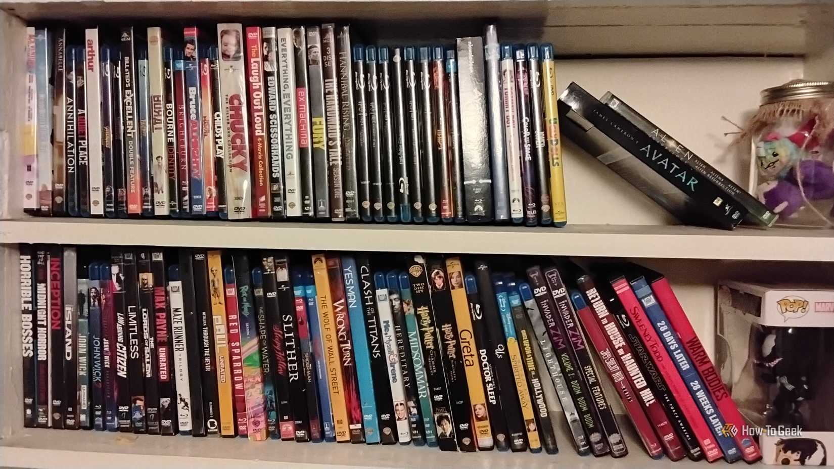 Two shelves of DVDs and Blu-rays, placed side by side.