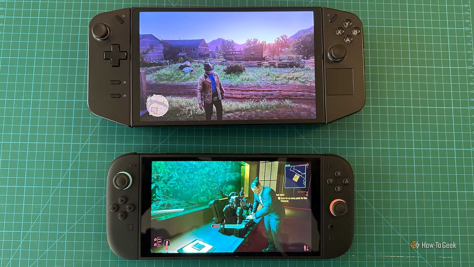 A Lenovo Legion Go and a Switch 2 stacked vertically on a hobby grid pad.