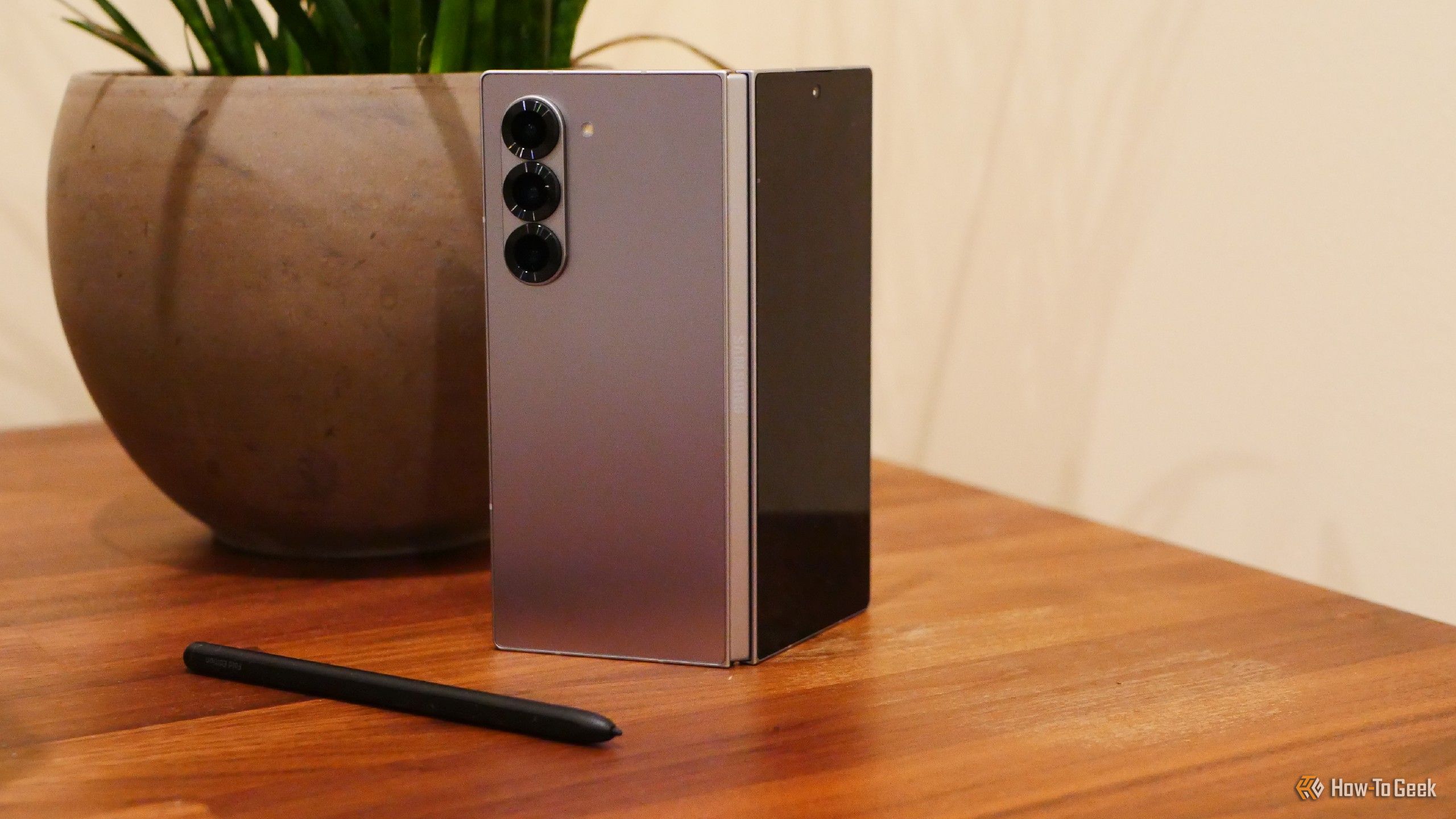 A Samsung Galaxy Z Fold 6 next to a house plant.