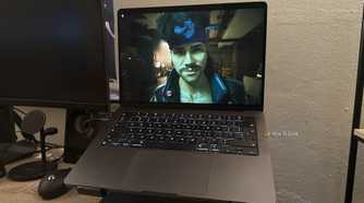 Cyberpunk 2077 is running on a MacBook.