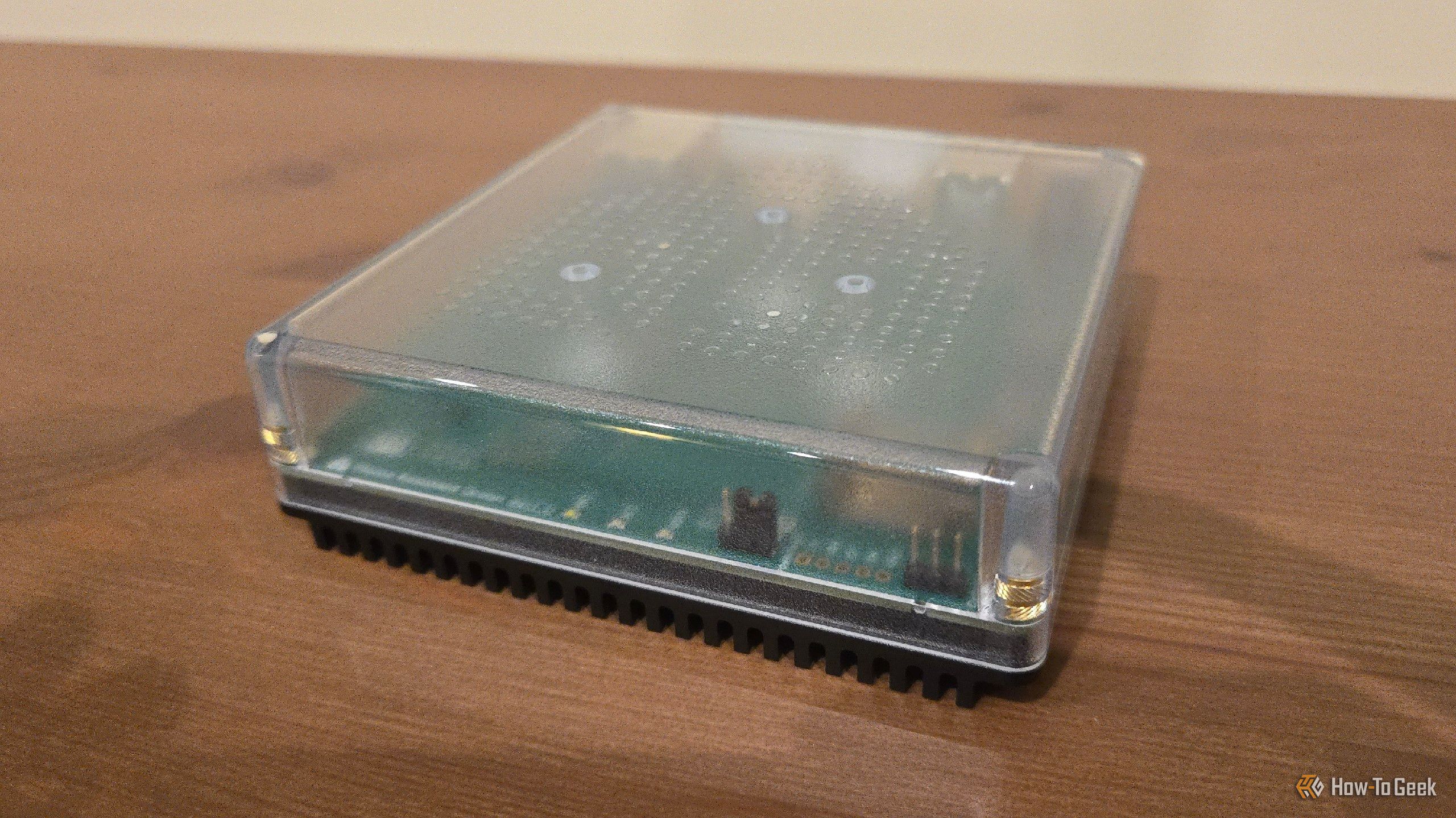 Home Assistant Green on an entertainment stand.