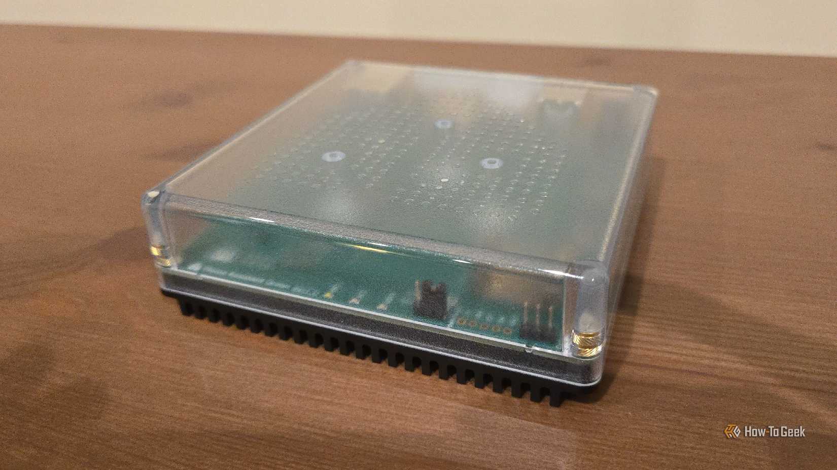 Home Assistant Green on an entertainment stand.