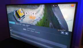 Steam on a TV screen installing the game Dirt Rally.