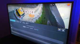 Steam on a TV screen installing the game Dirt Rally.