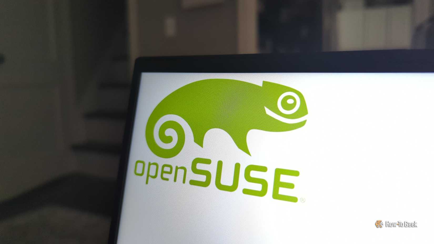 openSUSE Linux logo on the laptop panel.