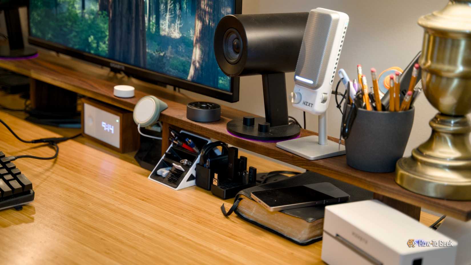 Overview of a desk with a desk shelf capable of raising speakers, microphone and more to a better height.