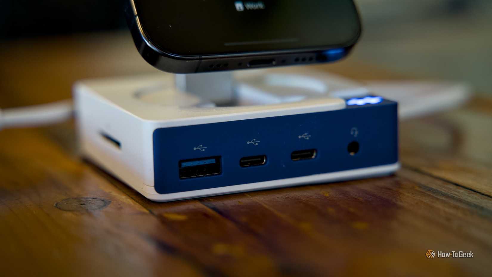 The front and side ports of the Hyper HyperDrive Flex MagCharge USB-C Hub with an iPhone mounted to the MagSafe puck.