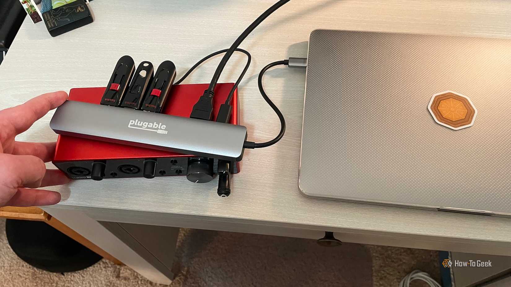 A laptop, three external flash drives, and a recording interface connected to the Plugable 9-in-1 USB-C Hub.