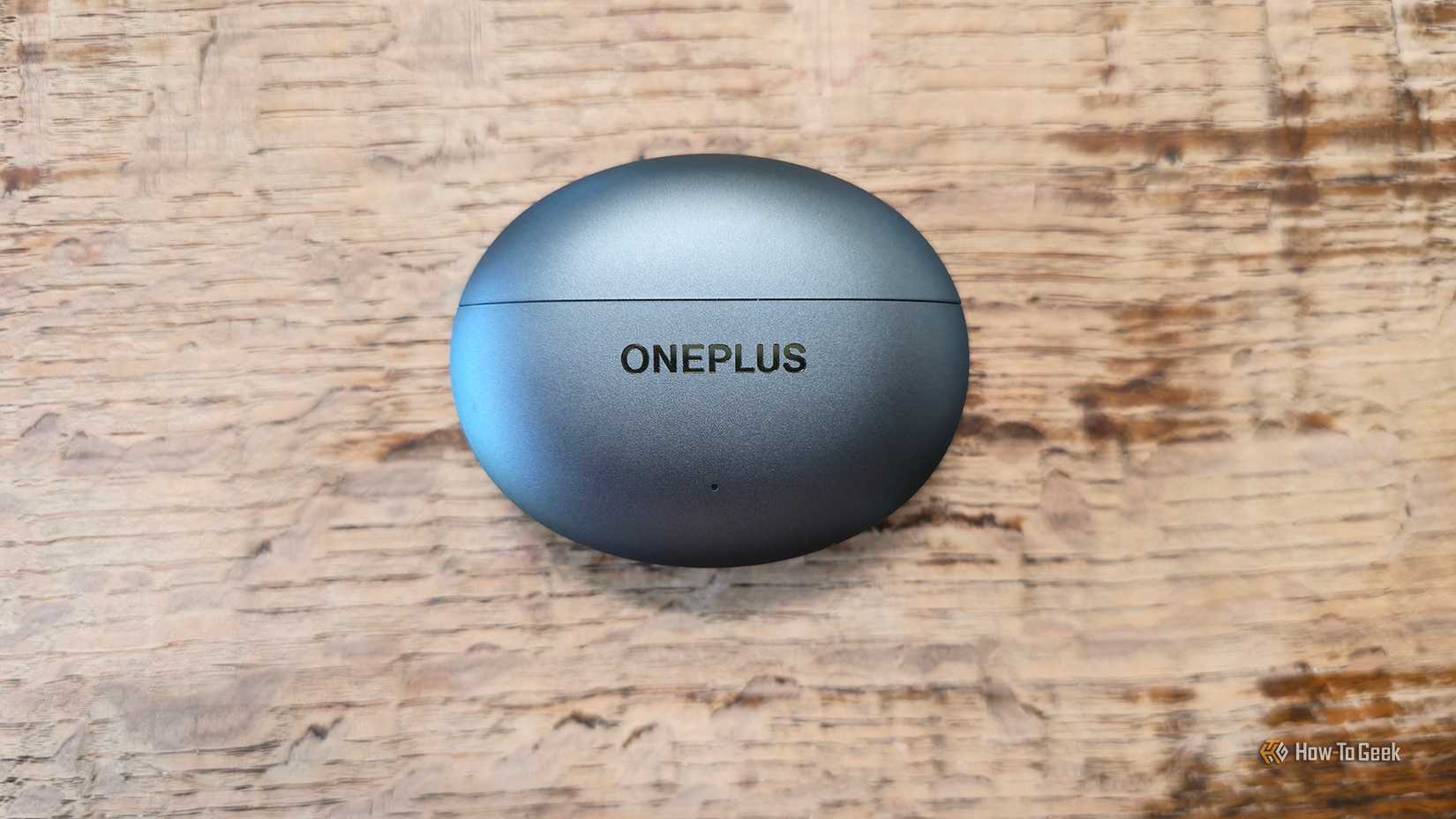 The OnePlus Buds 4 charging case closed on a table.