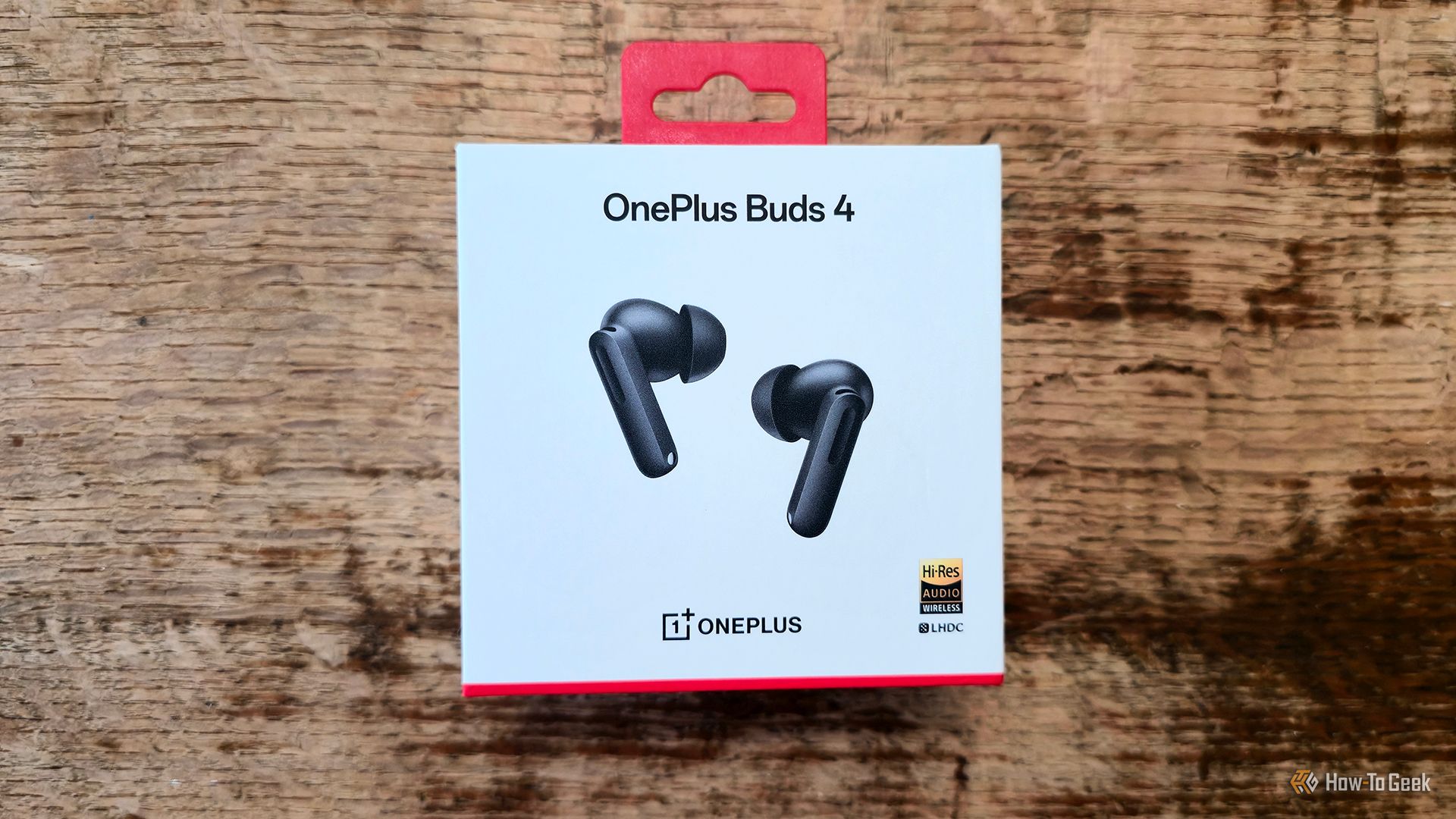 The OnePlus Buds 4 earbuds in their box.