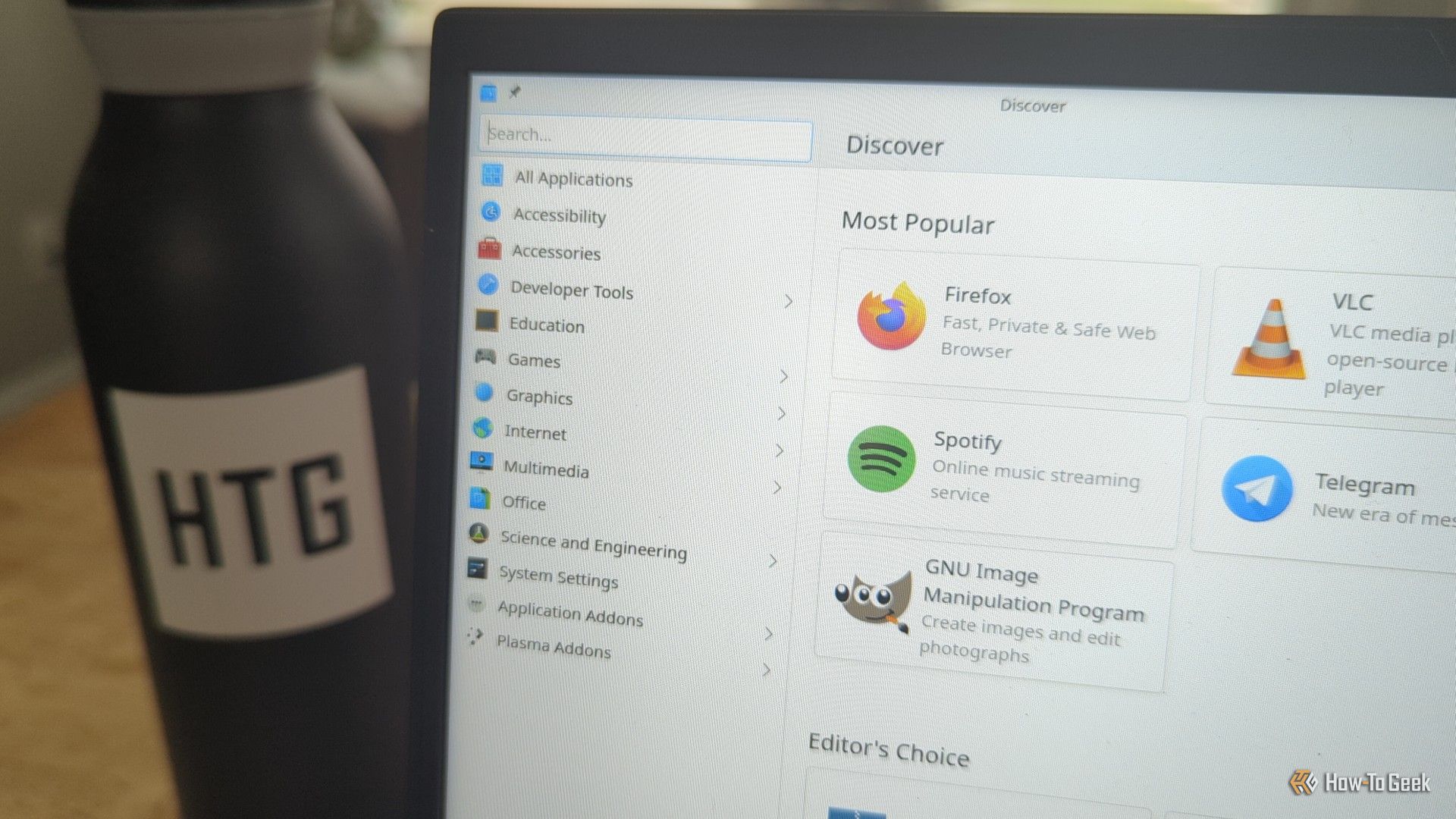A laptop computer screen with a Linux software browser visible showing several apps available to download.