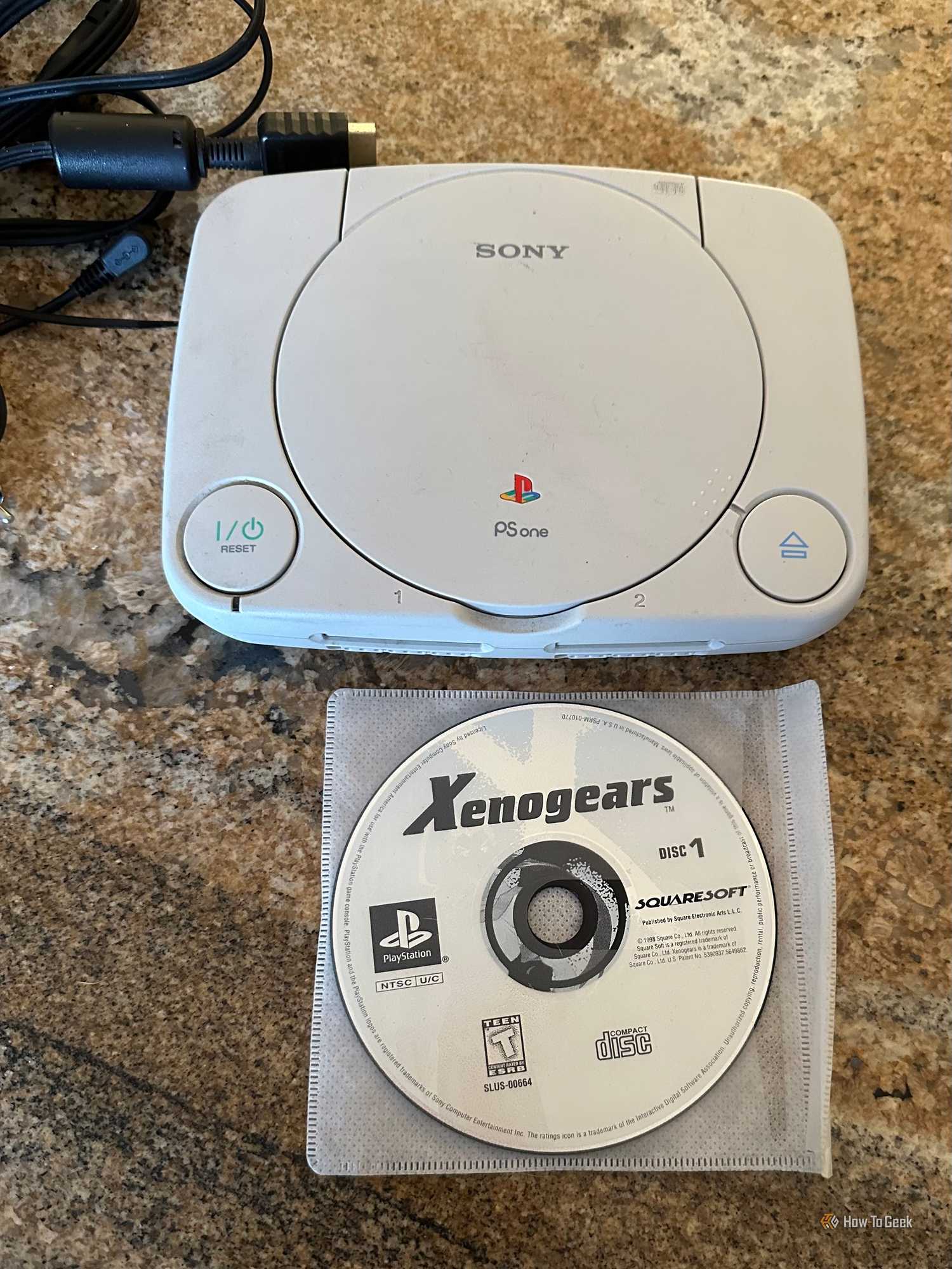 A PSOne with loose Xenogears discs.