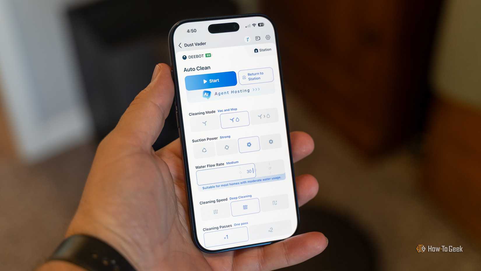 The Ecovacs app running on an iPhone 17 Pro held in a hand showing settings for the Deebot X11 Omnicyclon.