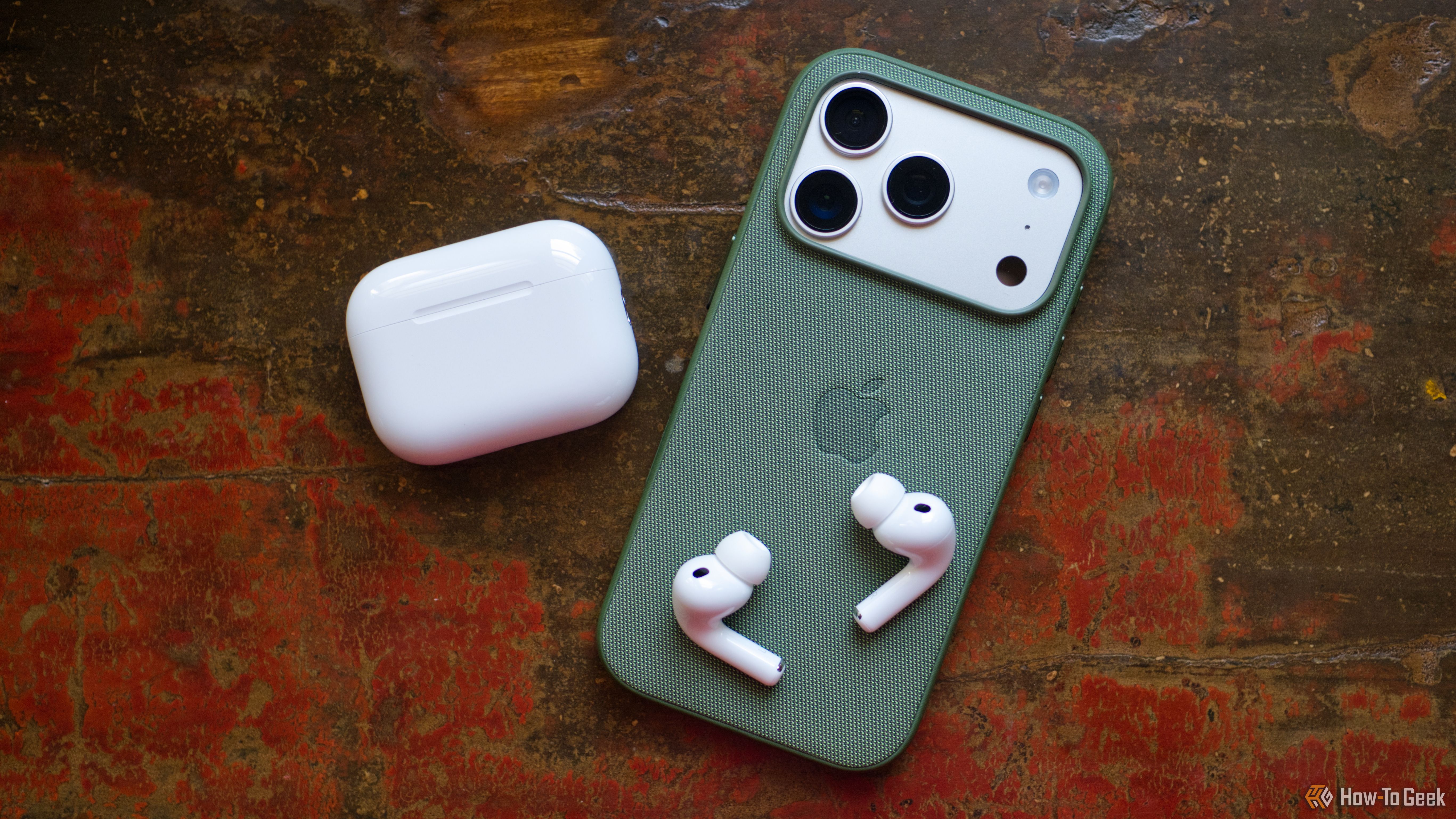 Apple AirPods Pro 3 with iPhone 17 Pro face down.