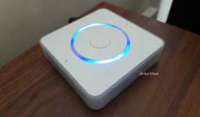 Home Assistant Voice Preview Edition on a shelf with lights activated.