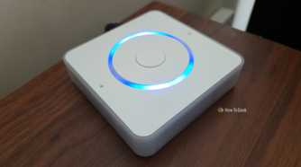 Home Assistant Voice Preview Edition on a shelf with lights activated.