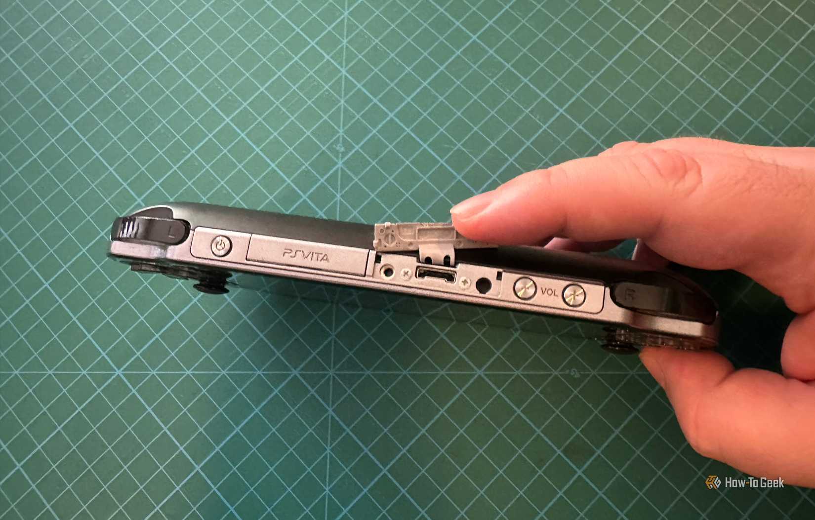 The mystery port on top of the PS Vita open and visible.