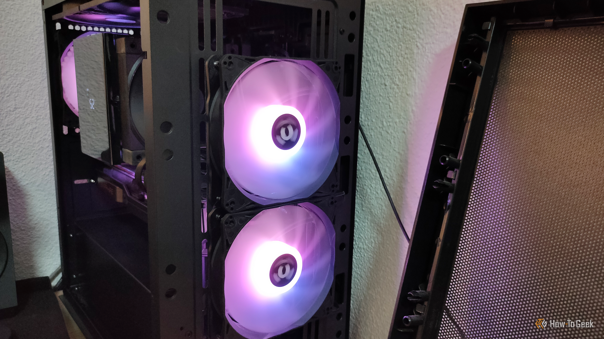 A desktop PC with two RGB fans and the front panel detached.