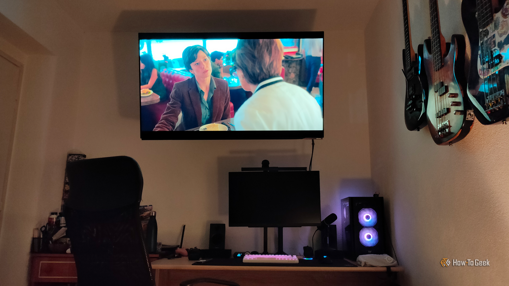 A wall-mounted OLED TV connected to a desktop PC being used to watch "Fargo."