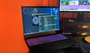 The Kubuntu Focus M2 Gen 6 laptop on a desk with a software updater and Linux terminal open.