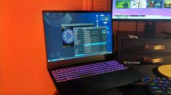 The Kubuntu Focus M2 Gen 6 laptop on a desk with a software updater and Linux terminal open.