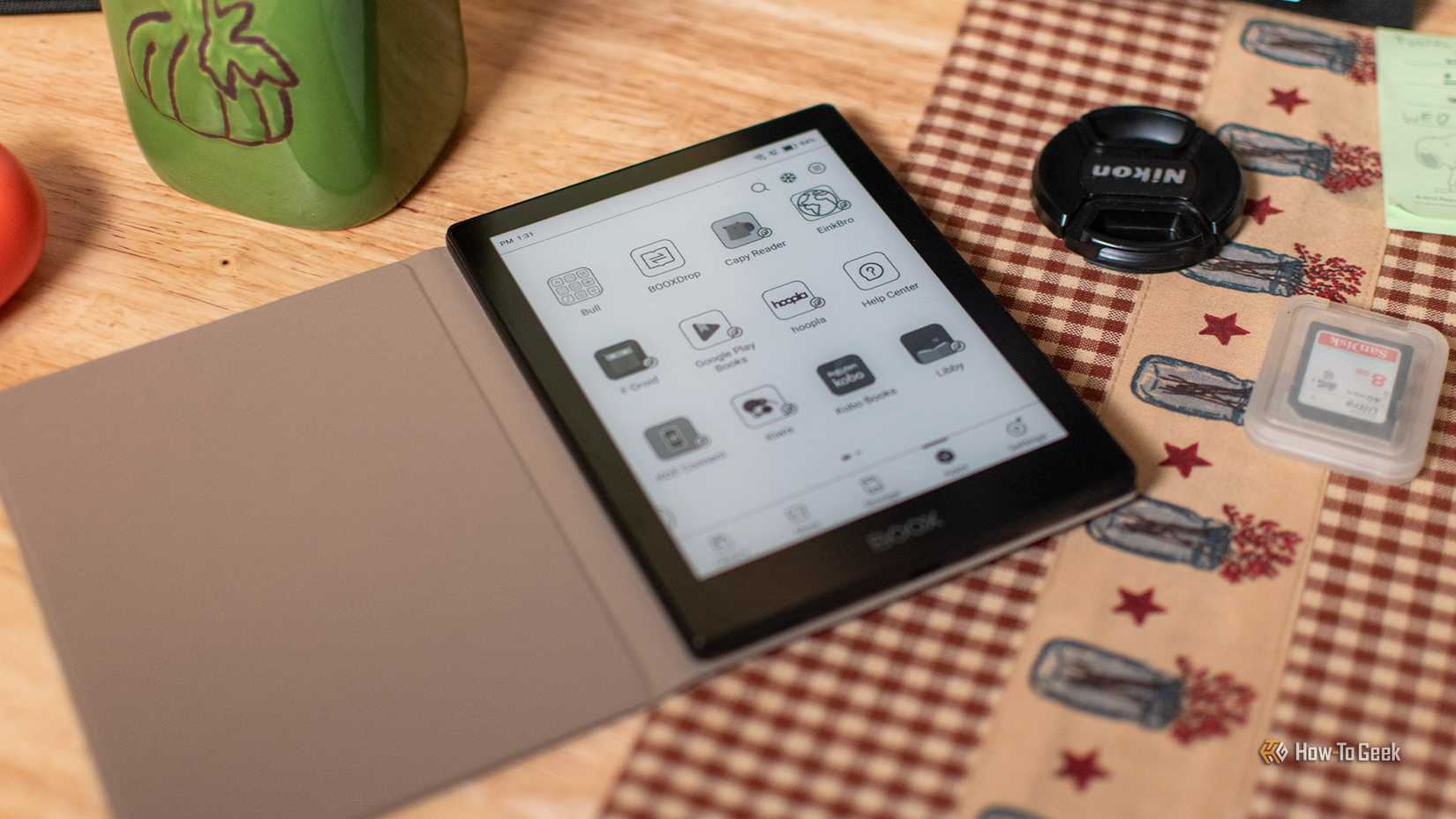 A BOOX Poke 5 eReader sitting on a table with its app list visible.