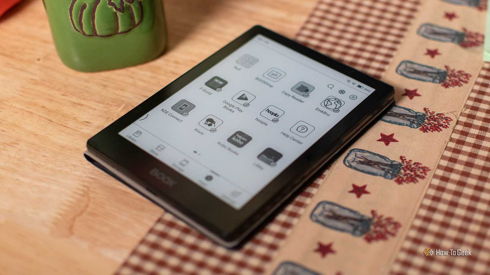 A BOOX Poke 5 sitting on a table with its home screen open.