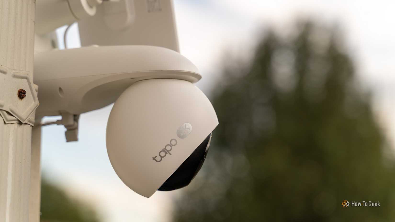 The TP-Link Tapo C660 Kit 4K solar powered security camera with a blurred tree in the background.
