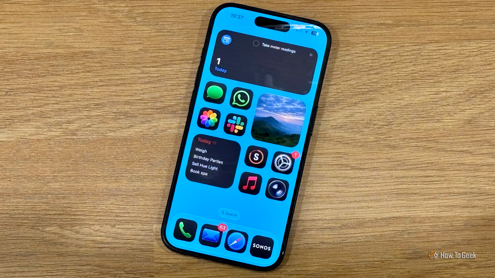 An iPhone 15 Pro showing a custom weather widget with an image representing the current weather conditions.