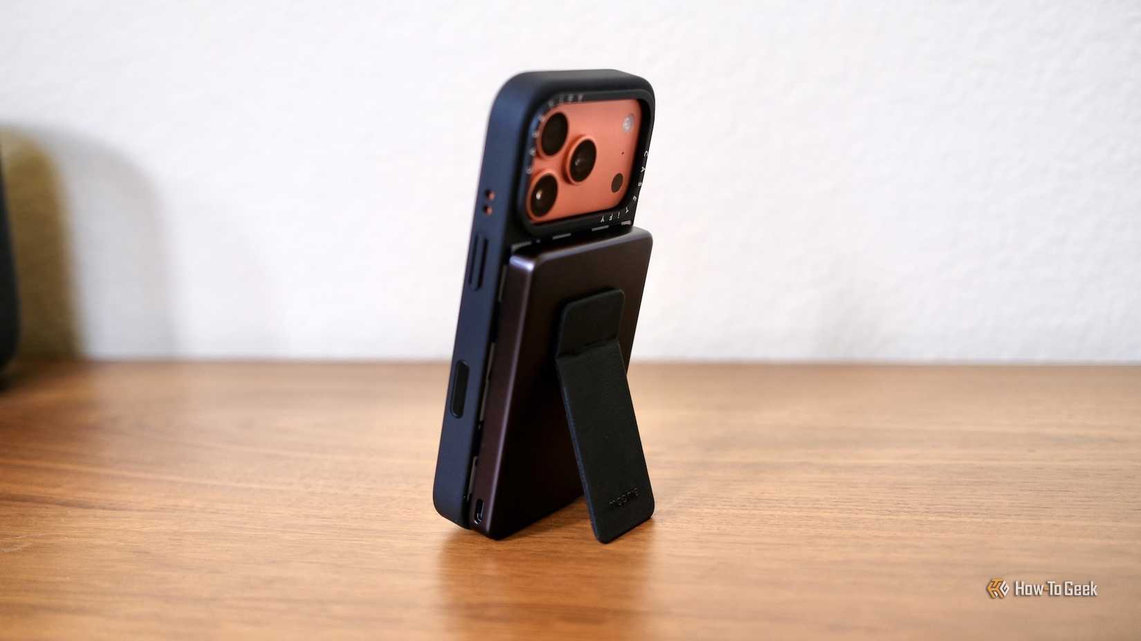 Mophie Powerstation Wireless Slim with Stand with iPhone standing vertically.
