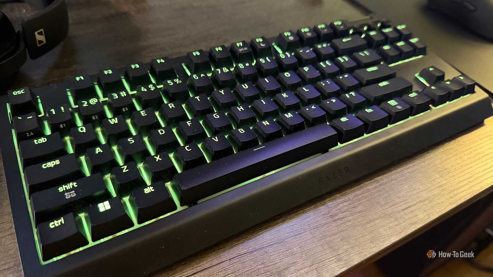 The Razer BlackWidow V4 Tenkeyless Hyperspeed at an angle with lime green RGB.