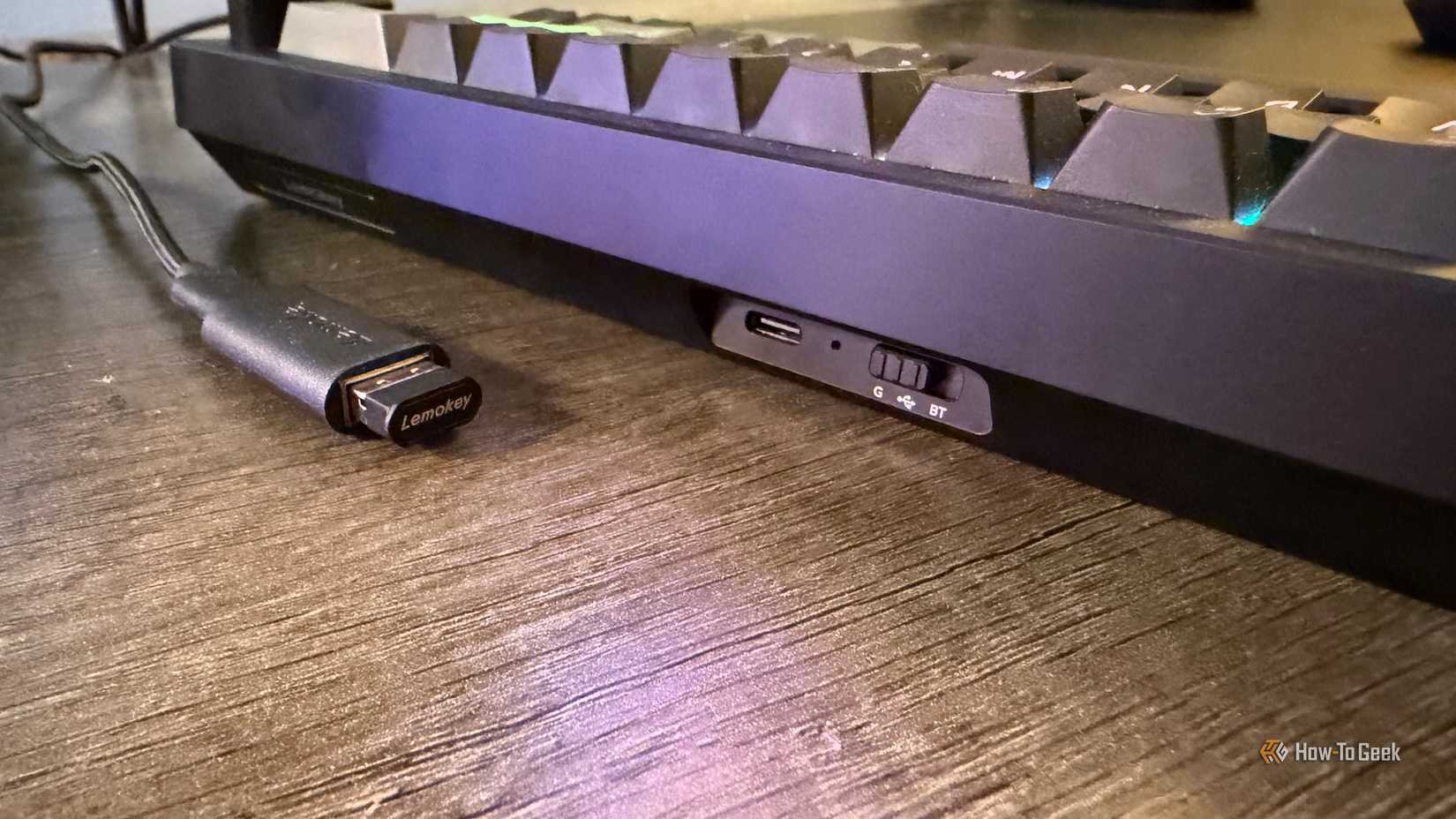 The connection mode switch and 2.4 GHz adapter for the Lemokey P2 HE.