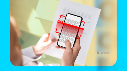 Person holding a document while scanning text with a smartphone, highlighted by a red scanning overlay.