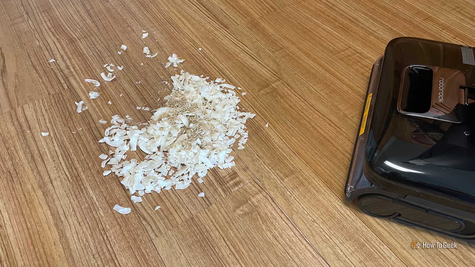Coconut shreds, rice, and water set up for the Roborock F25 Ultra to clean.