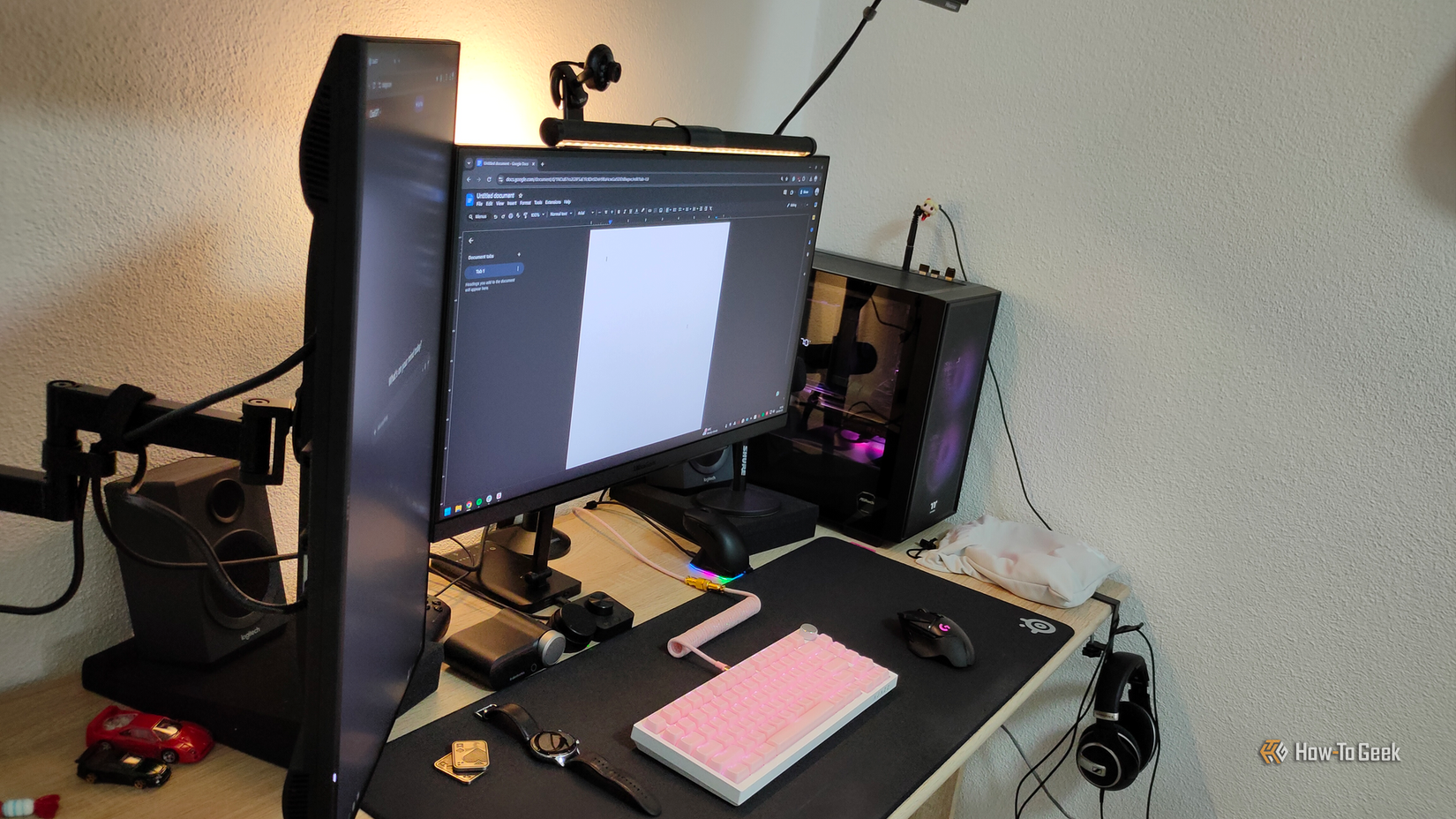 A vertical  monitor with a monitor arm and a main monitor on a desktop PC.