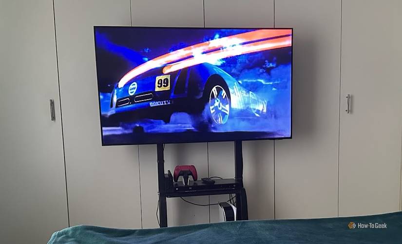 Samsung TV on a mobile stand in the bedroom.