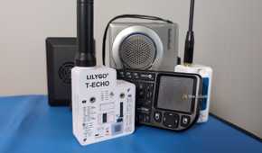Several small electronic devices including LoRa radios, a mini keyboard, a cassette recorder, and a Raspberry Pi computer.